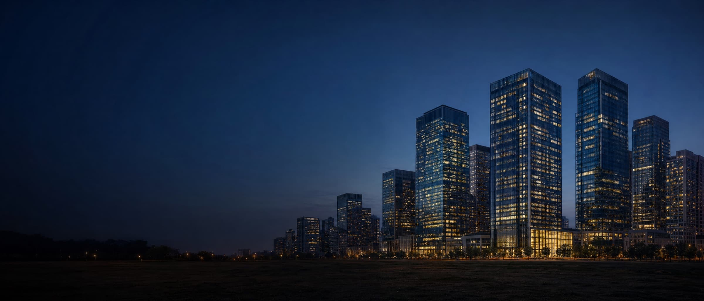 Downtown skyline at dusk with warm lights glowing in the office towers